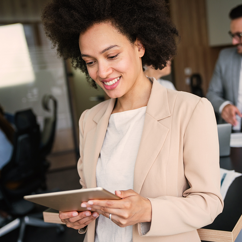 Portrait of a successful business woman using digital tablet in office Portrait of a successful african business woman using digital tablet in office